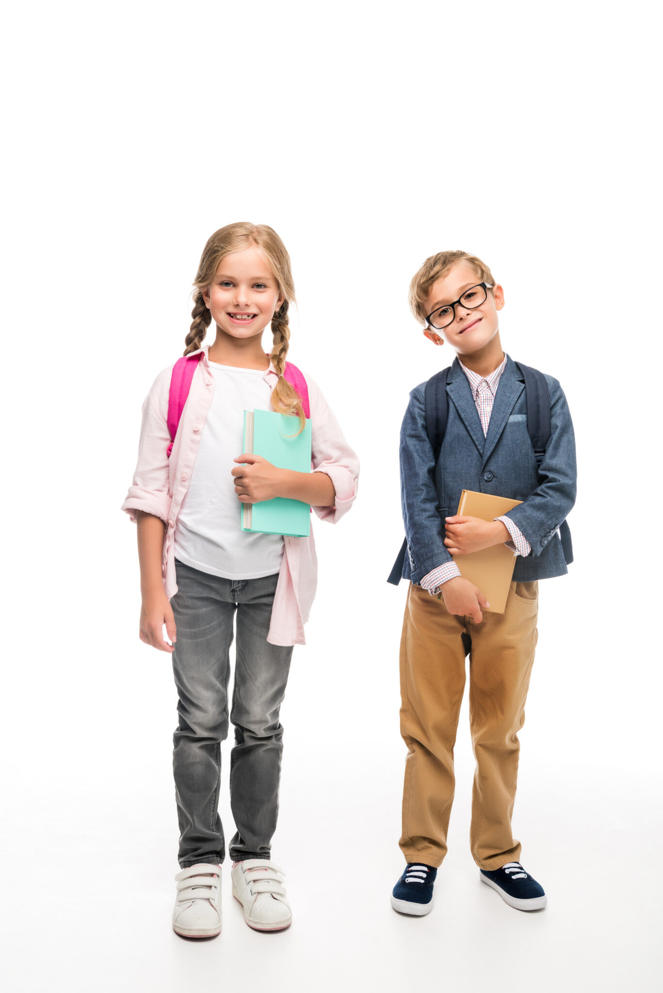 schoolgirl and schoolboy with backpacks and books, isolated on white